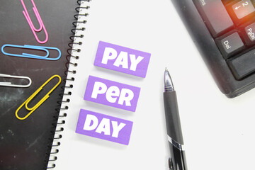 keyboard, notebook, click paper and the word pay per day