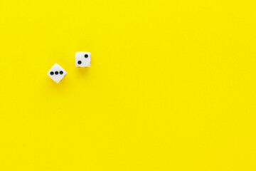 Two dice showing different sides on yellow background. Playing cube with numbers. Items for board games. Flat lay, top view with copy space.