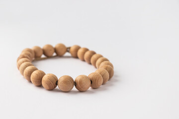 Wooden beads, braslet on white background. Natural wood baby teether. Eco-friendly children toy. 