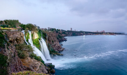 Lower Düden waterfall and rainbow formed over the sea. Photo from Antalya, Turkey