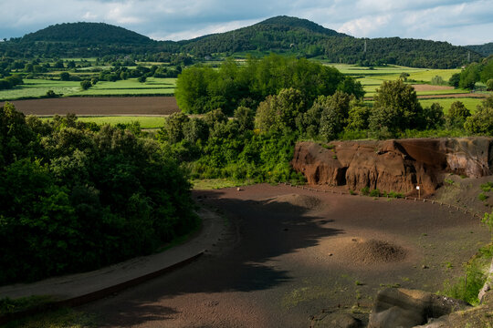 scenic sunset landscape of catalan region known as Garrotxa in spanish Catalunya region in spring with poppy flowers fields, known for its mountains and volcanoes