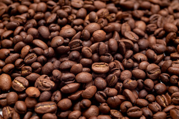 Coffee beans background. Roasted coffee full frame. Texture of dark coffee beans.