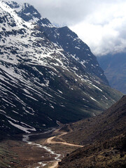 A view of serpentine river and zigzag road situated at 16,500 ft altitude with snow-covered...