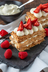  Strawberries, raspberry and Cream Mille Feuille dessert on black stone plate