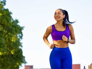 Asian woman running early in the morning. Attractive looking woman keeping fit and healthy.