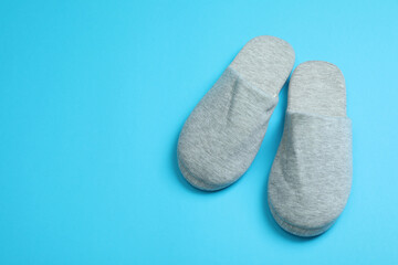 Pair of house slippers on blue background
