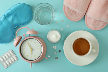 Female sleep routine accessories on blue background