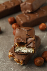 Candy bars and nuts on gray textured table