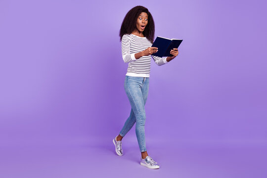 Full size profile side photo of young black girl happy smile read book amazed information isolated over violet color background