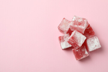 Delicious turkish delight cubes on pink background