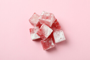 Delicious turkish delight cubes on pink background