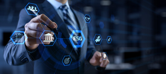 ESG environmental social governance business strategy investing concept. Businessman pressing button on screen.