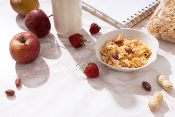 Sunny morning, tasty corn flakes,fruits,milk on the table.Healthy and delicious breakfast