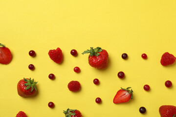 Delicious fresh berry mix on yellow background