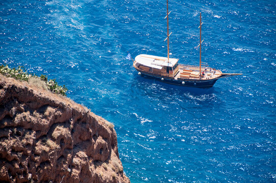 Traditional gulet boat in Santorini island, aerial view from the top of the caldera