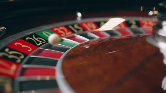 Close up of roulette wheel at the casino in motion. The wheel ball is spinning. Concept of casinoand gambling.