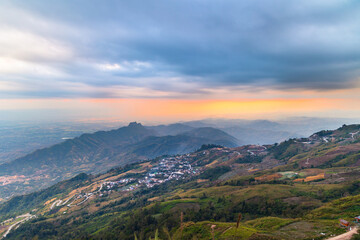 Beautiful landscape of Phu tub berk. agriculture village on the mountain with layer mountain and cloudy with sunset background.