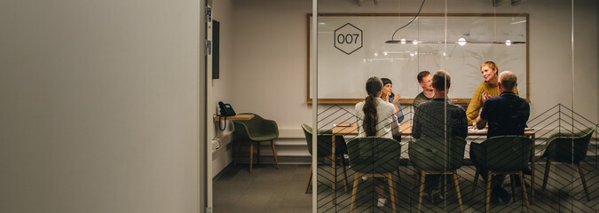 Creative team applauding woman executive in meeting