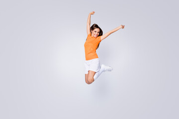 Fototapeta na wymiar Full length photo of excited lady player soccer team jump up raise fists champion league wear football uniform t-shirt shorts cleats long knee socks isolated white color background