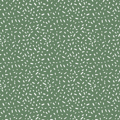 Cute modern vector seamless pattern in polka dot stile. Chaotic terracotta dots on a green background pattern.