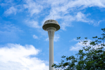 Water tower tank against blue sky.