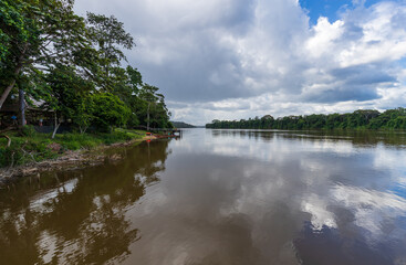 Fototapeta na wymiar Suriname River Surrounded By Forest Scenery In Brokopondo District