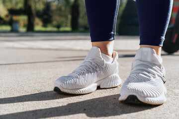 Feet of a woman dressed in sportswear and sneakers for running
