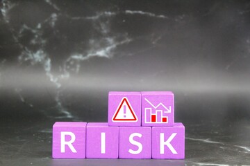 purple wooden cubes with the word risk