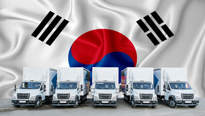 South Korean flag in the background. Five new white trucks are parked in the parking lot. Truck,...