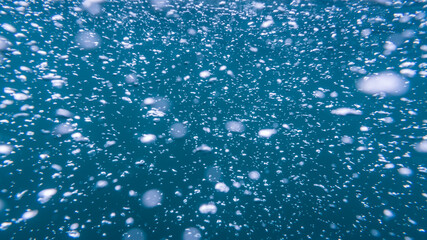 Blurred background image of air bubbles under water
