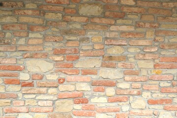 Brick wall without plaster, there is mortar in the joints between the bricks
