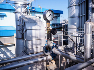 Pressure gauge of measuring instrument close up in industry zone at power plant.