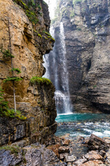 Fototapeta na wymiar Hiking trail in the Rocky Mountains. Waterfall in the Johnston Canyon. Banff National Park, Alberta, Canada
