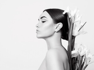 Fototapeta premium Portrait of a beautiful woman with a bouquet of flowers