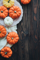 Autumn composition of miniature decorative pumpkins on a wooden table.