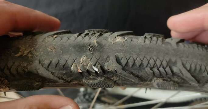 Repairer repairs a punctured bicycle tire