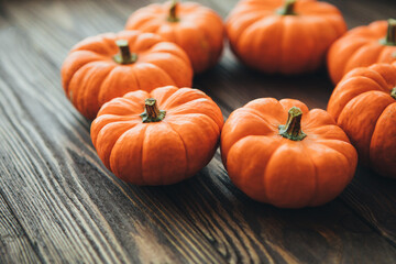 Autumn composition of miniature decorative pumpkins on a wooden table.