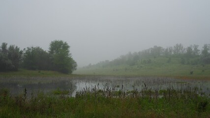 Morning fog rises above the surface of the pond. A quiet and peaceful place away from the hustle...