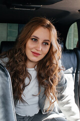 Fototapeta na wymiar Young beautiful girl sitting in a car.