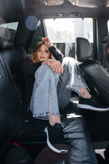 Young beautiful girl sitting in a car.