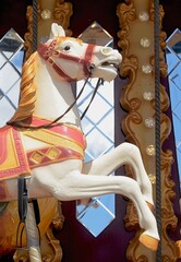 Fototapeta na wymiar Carrousel horse and blue sky background