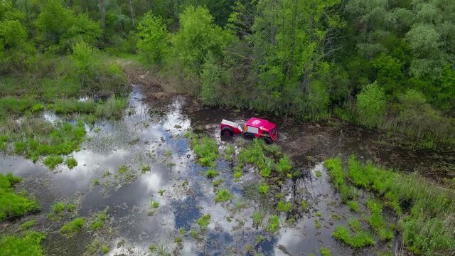 Sherp rescue is a Ukrainian all-terrain amphibious vehicles for rough and soggy terrain. Sherp drives through the swamp. Aerial drone view.