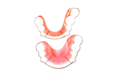 Top view of Red retainer lower and upper teeth to maintain the teeth after removing the braces isolated on white background. - obrazy, fototapety, plakaty