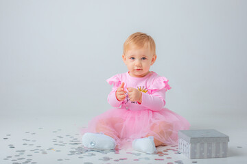 baby girl celebrates birthday on white background