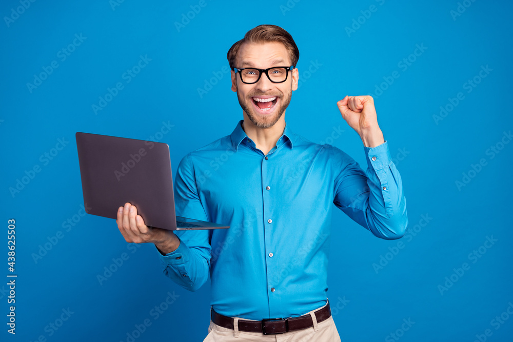 Wall mural photo of young business man happy positive smile use laptop rejoice victory fists hand isolated over