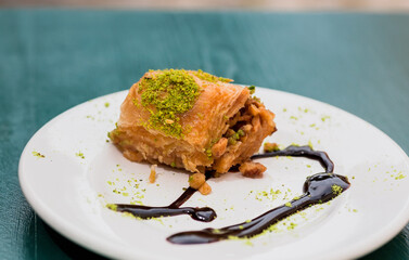 Small piece of tasty sweet baklava. Traditional turkish dessert on table of local cafe. Natural baked food