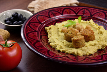 Chickpea hummus with falafel close-up stock images. Traditional homemade hummus served with pita bread still life stock images. Delicious Middle Eastern cuisine photo