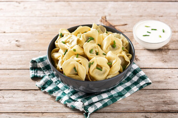 Pelmeni dumplings on rustic wooden table.Typical russian food