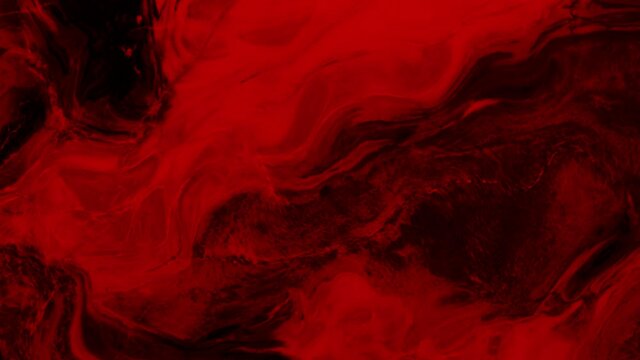 Animation of vibrant coloured red liquid flowing in hypnotic motion on black background