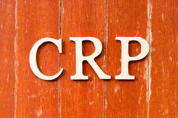 Alphabet letter in word CRP (abbreviation of C-Reactive Protein Test) on old red color wood plate background